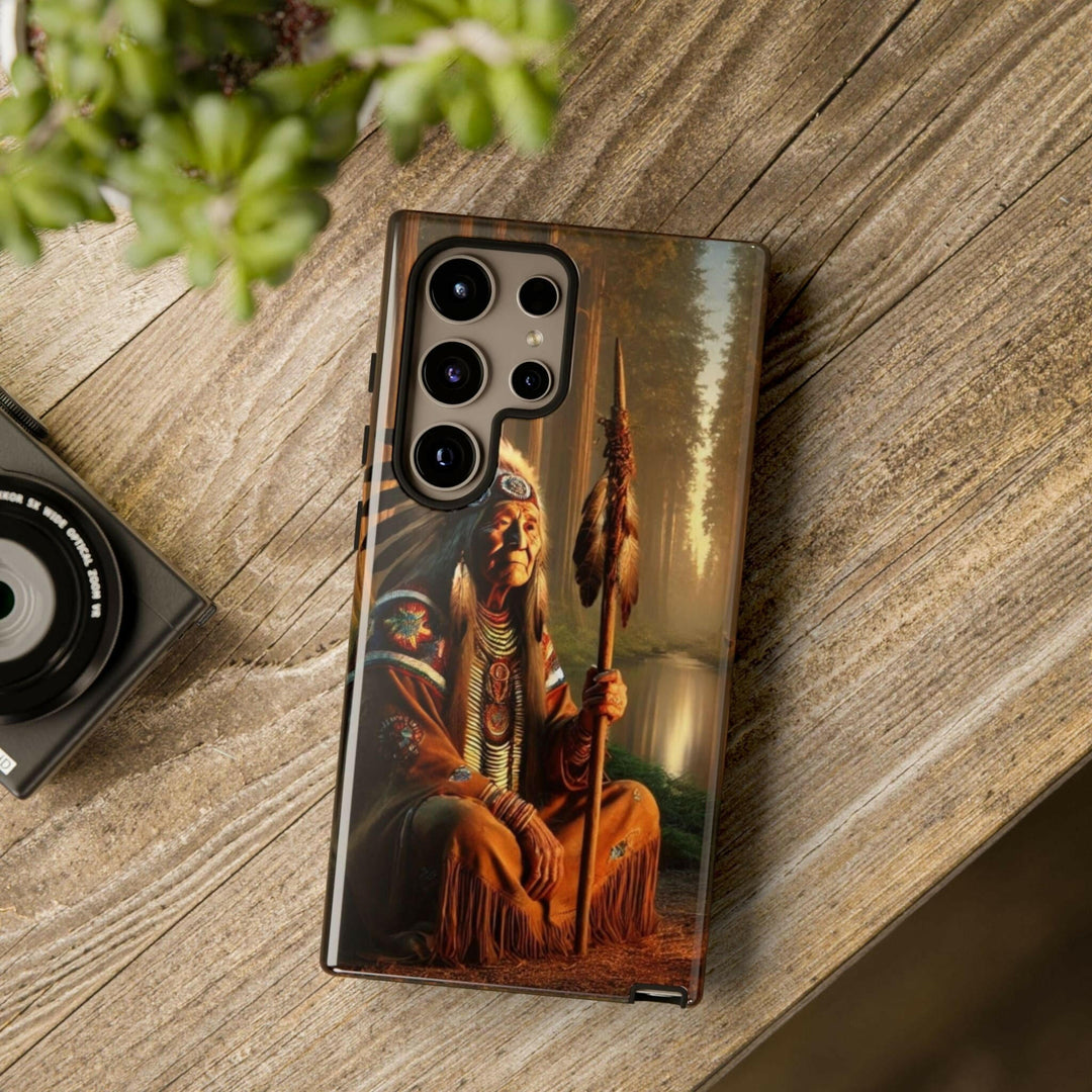 Phone case featuring a serene Native American elder holding a staff by a tranquil river. Detailed art for heritage appreciation.