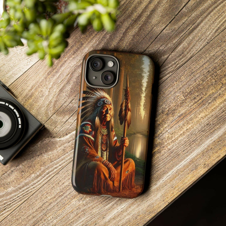 Phone case featuring a serene Native American elder holding a staff by a tranquil river. Detailed art for heritage appreciation.