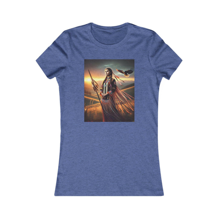 Heather Royal Blue T-shirt featuring an illustration of a Native American warrior woman with a spear, set against a dramatic sunset. Represents strength, heritage, and cultural pride.