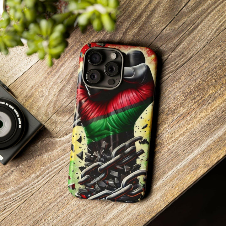 Black Pan-African fist phone case with chains breaking free, symbolizing strength and liberation. Durable and stylish for cultural expression.