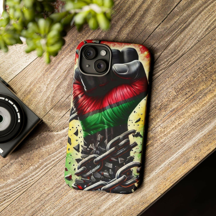 Black Pan-African fist phone case with chains breaking free, symbolizing strength and liberation. Durable and stylish for cultural expression.