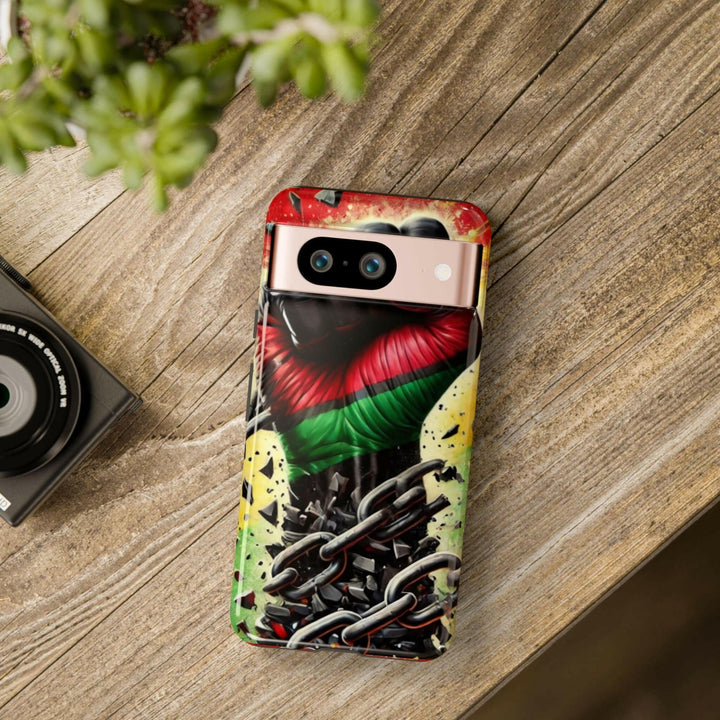 Black Pan-African fist phone case with chains breaking free, symbolizing strength and liberation. Durable and stylish for cultural expression.