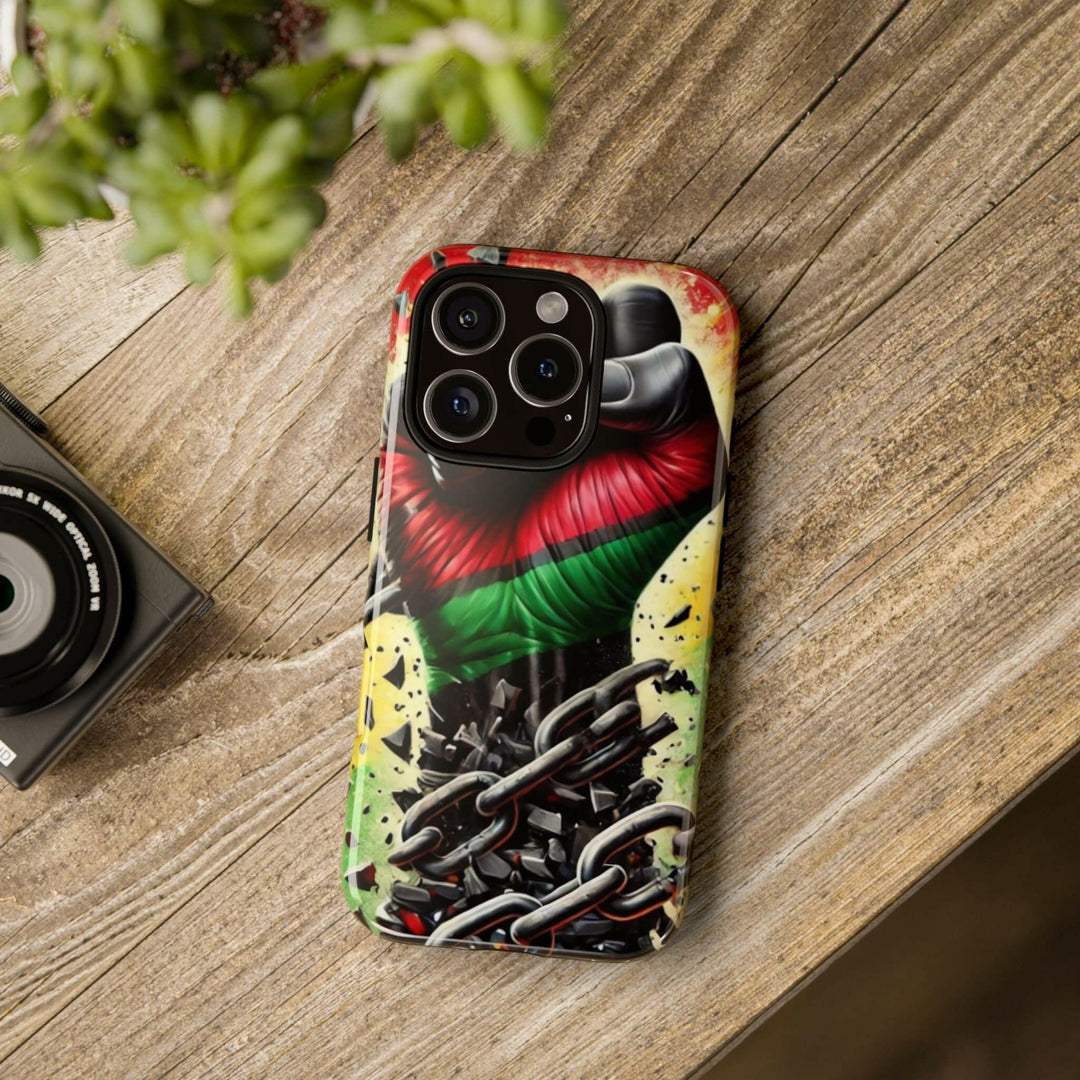 Black Pan-African fist phone case with chains breaking free, symbolizing strength and liberation. Durable and stylish for cultural expression.