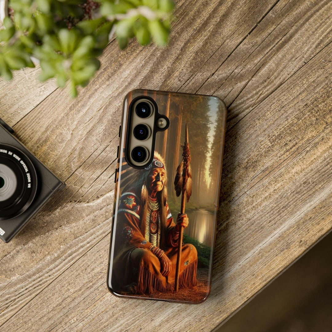 Phone case featuring a serene Native American elder holding a staff by a tranquil river. Detailed art for heritage appreciation.