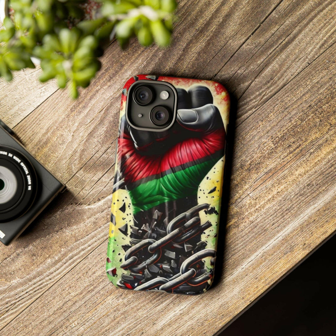 Black Pan-African fist phone case with chains breaking free, symbolizing strength and liberation. Durable and stylish for cultural expression.