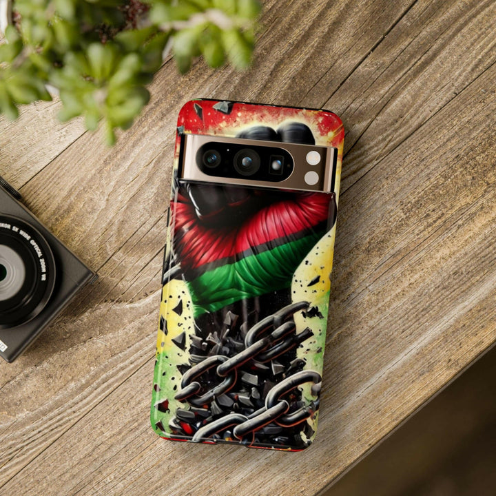 Black Pan-African fist phone case with chains breaking free, symbolizing strength and liberation. Durable and stylish for cultural expression.