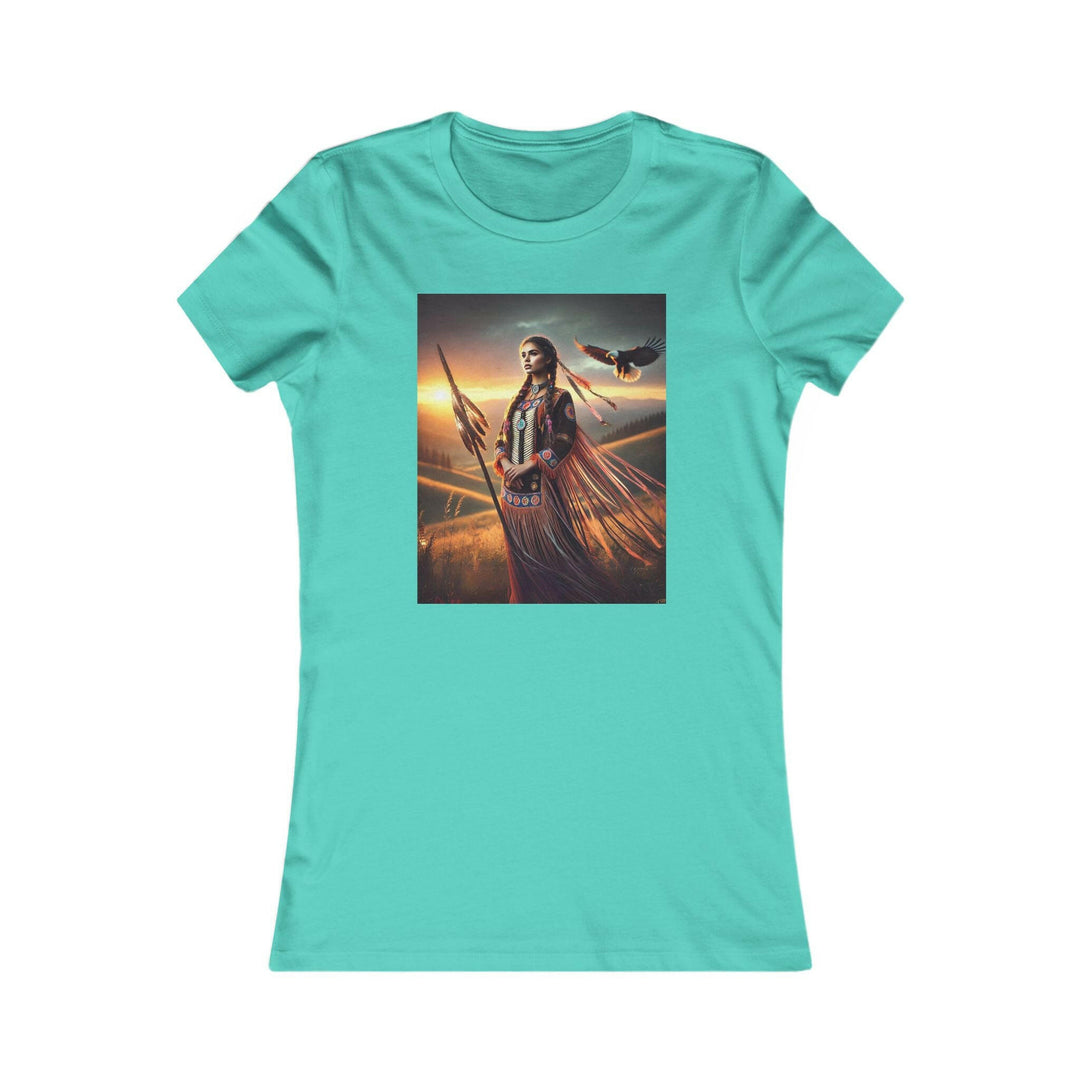 Teal T-shirt featuring an illustration of a Native American warrior woman with a spear, set against a dramatic sunset. Represents strength, heritage, and cultural pride.