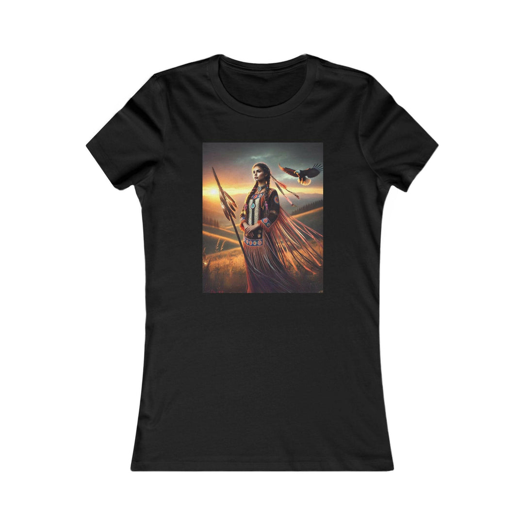 Black T-shirt featuring an illustration of a Native American warrior woman with a spear, set against a dramatic sunset. Represents strength, heritage, and cultural pride.