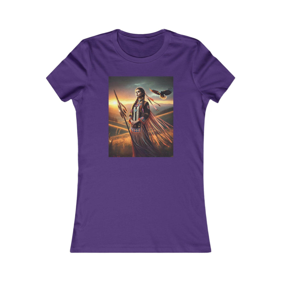 Purple T-shirt featuring an illustration of a Native American warrior woman with a spear, set against a dramatic sunset. Represents strength, heritage, and cultural pride.