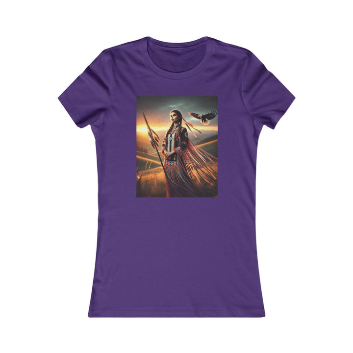 Purple T-shirt featuring an illustration of a Native American warrior woman with a spear, set against a dramatic sunset. Represents strength, heritage, and cultural pride.