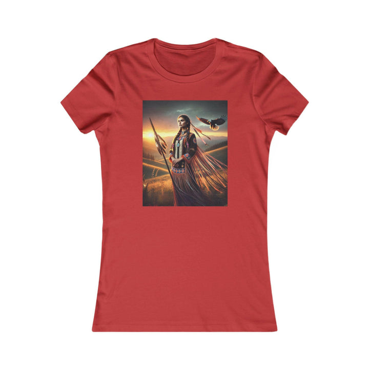 Red T-shirt featuring an illustration of a Native American warrior woman with a spear, set against a dramatic sunset. Represents strength, heritage, and cultural pride.