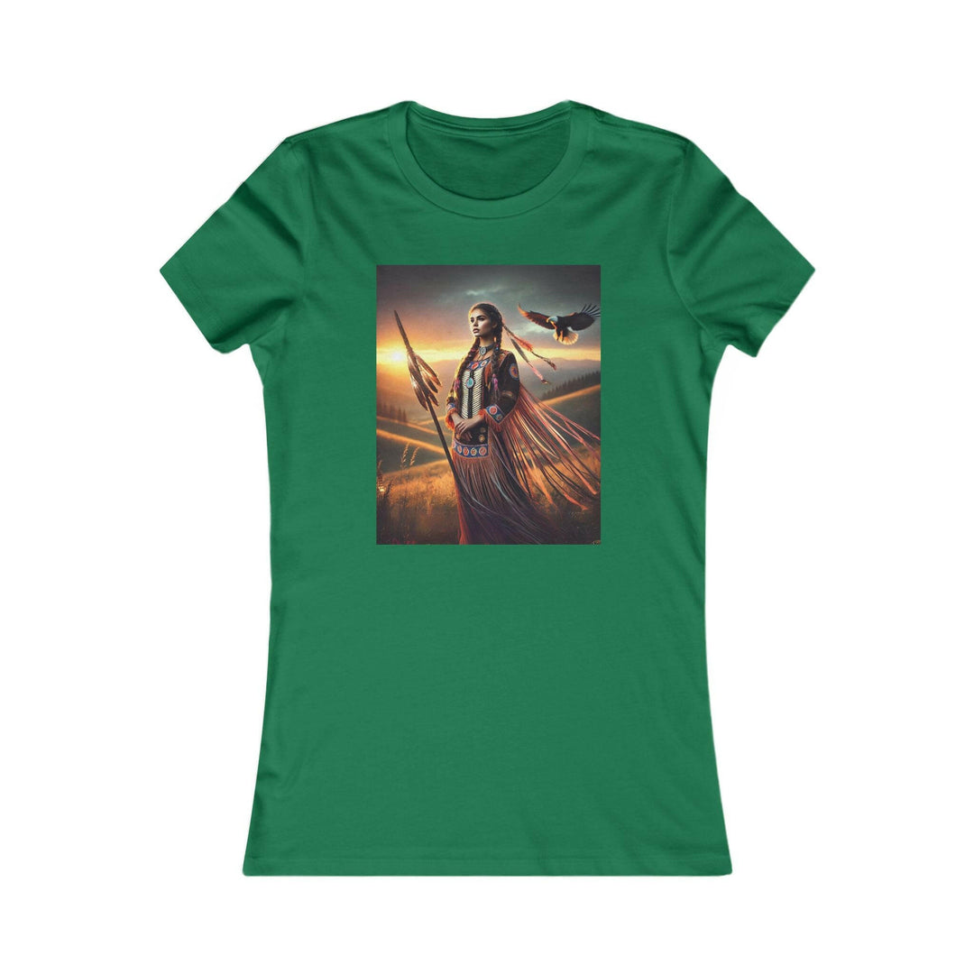 Kelly Green T-shirt featuring an illustration of a Native American warrior woman with a spear, set against a dramatic sunset. Represents strength, heritage, and cultural pride.