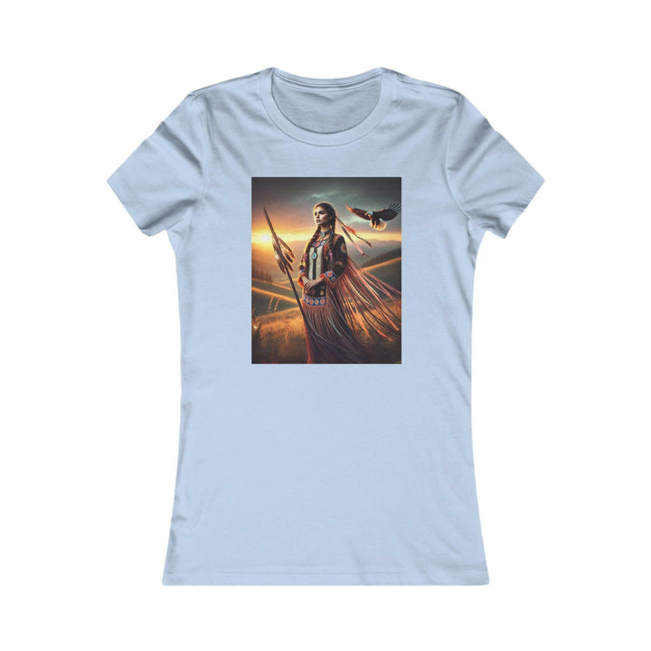 Baby Blue T-shirt featuring an illustration of a Native American warrior woman with a spear, set against a dramatic sunset. Represents strength, heritage, and cultural pride.