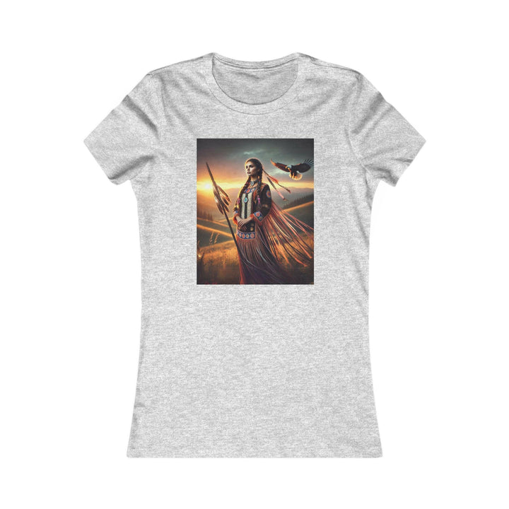 Sport Grey T-shirt featuring an illustration of a Native American warrior woman with a spear, set against a dramatic sunset. Represents strength, heritage, and cultural pride.