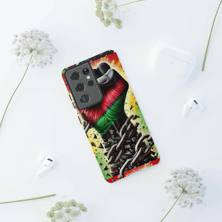 Black Pan-African fist phone case with chains breaking free, symbolizing strength and liberation. Durable and stylish for cultural expression.