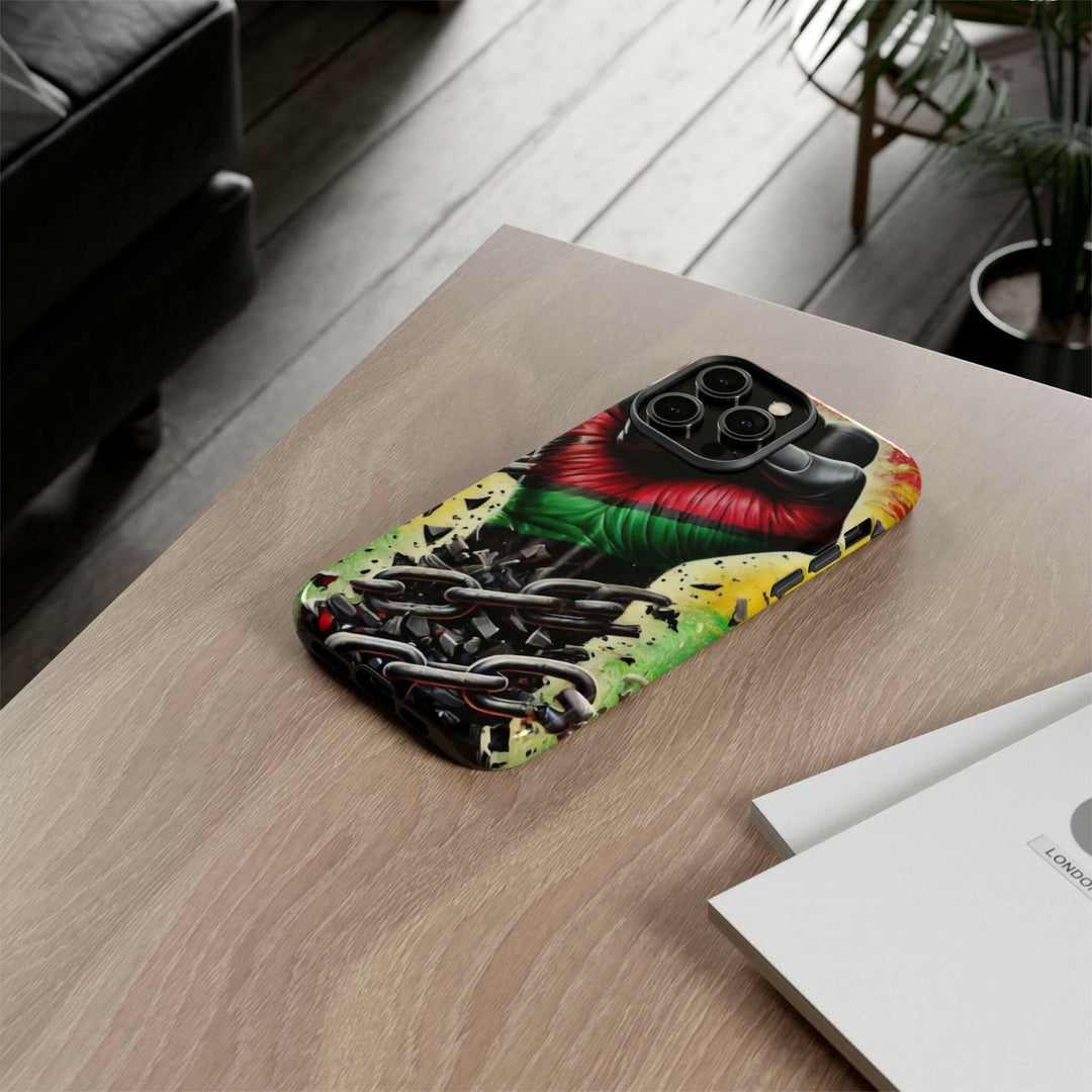 Black Pan-African fist phone case with chains breaking free, symbolizing strength and liberation. Durable and stylish for cultural expression.