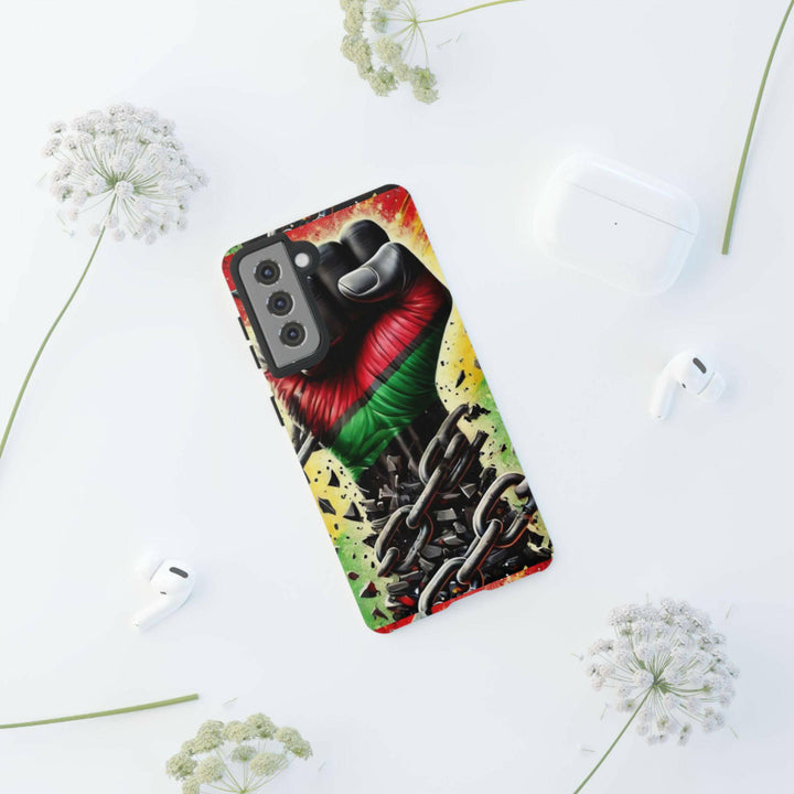 Black Pan-African fist phone case with chains breaking free, symbolizing strength and liberation. Durable and stylish for cultural expression.